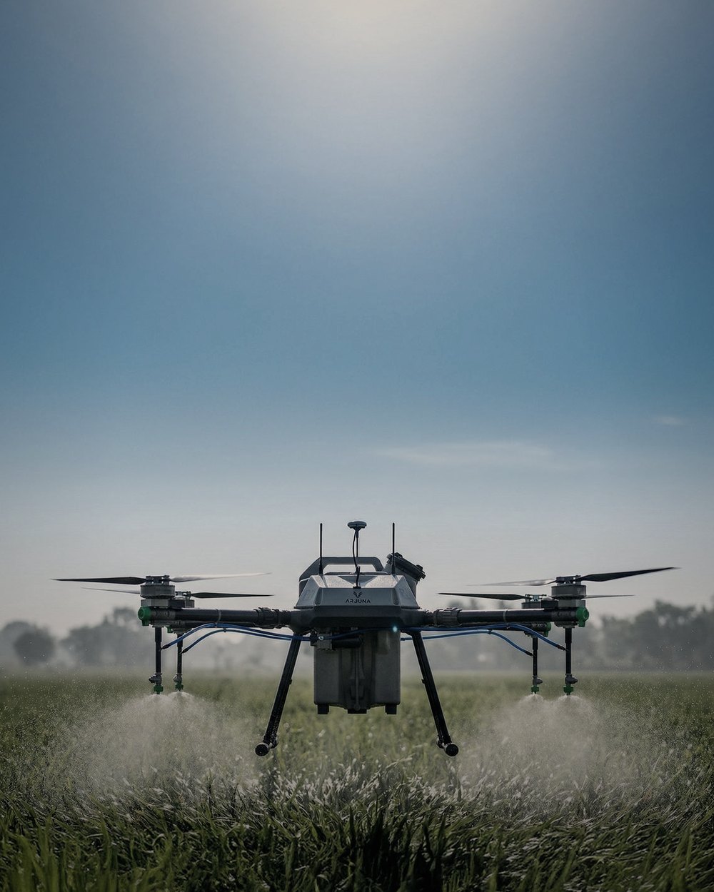 Agricultural drone spraying a field in daylight